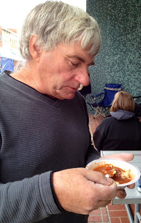 man eating chili and crackers