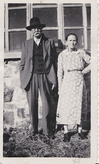 man with mustache and hat standing by a woman