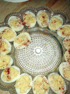 deviled eggs, sprinkled with papricka on a crystal tray